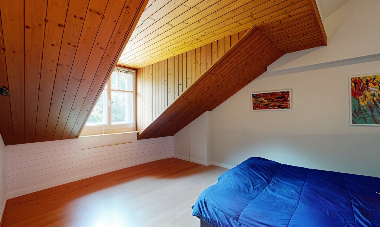 room with a vaulted wooden ceiling, wood finished floors, and wooden walls