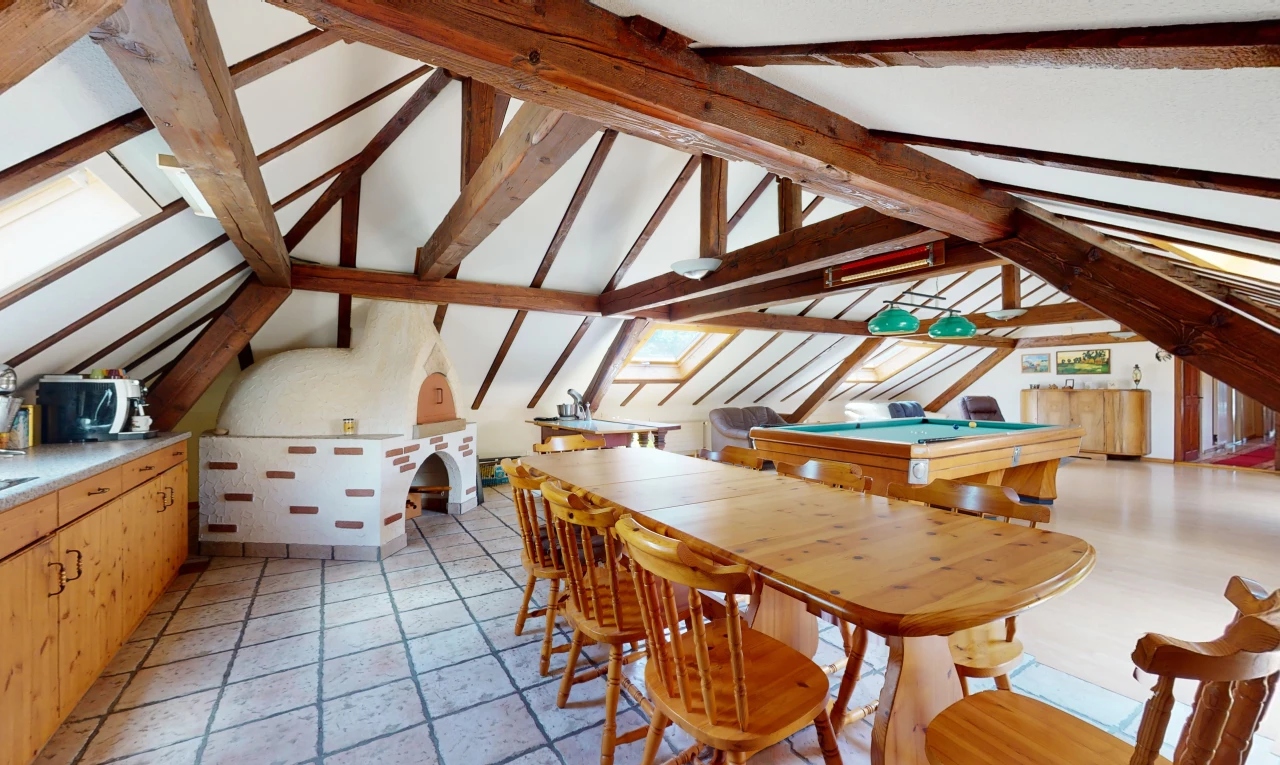 dining room featuring tile flooring and lofted ceiling with beams