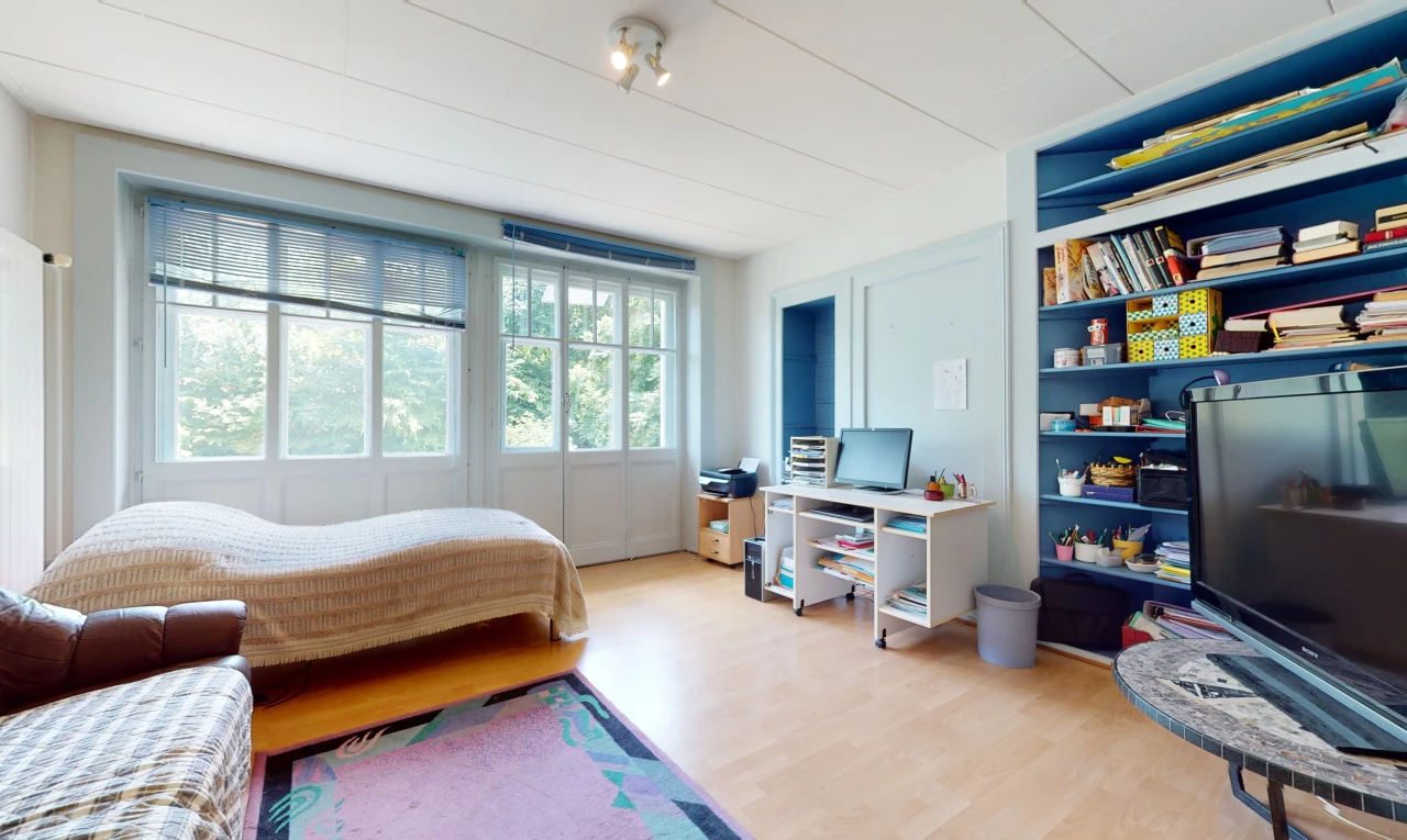 bedroom with hardwood floors, natural light, and TV