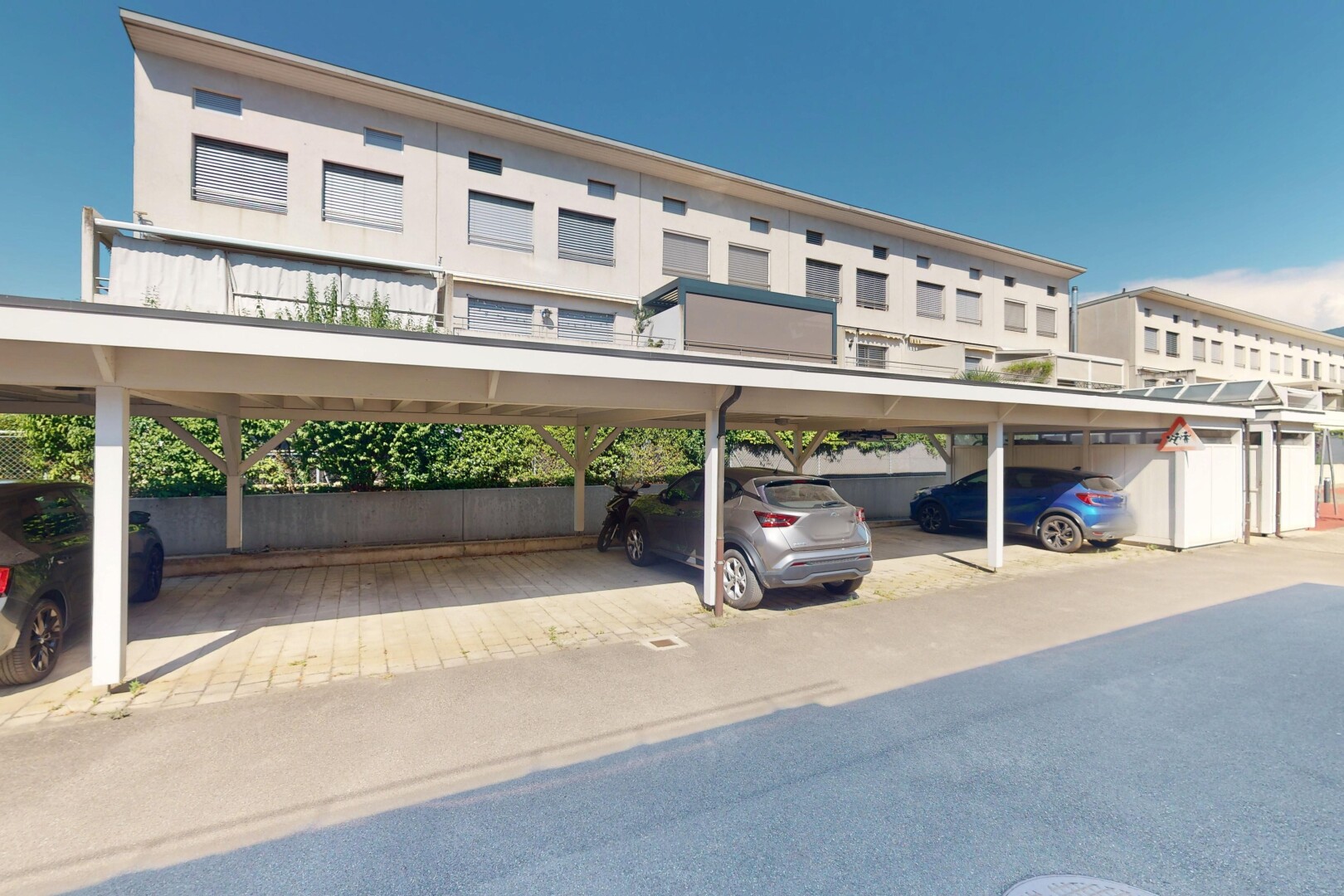 view of building exterior with covered parking