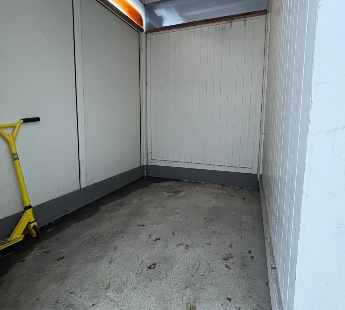 unfurnished room with unfinished concrete floors and a closet