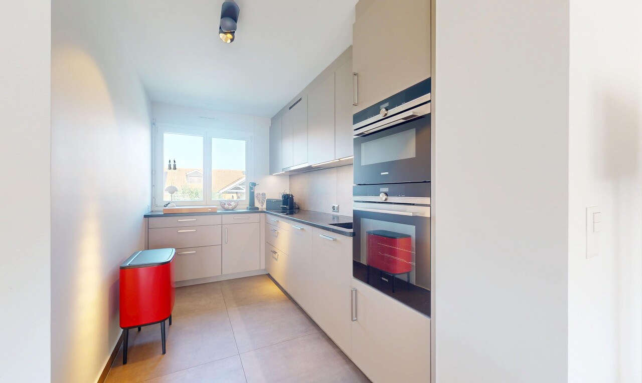 kitchen with double oven, white cabinets, and light tile patterned floors