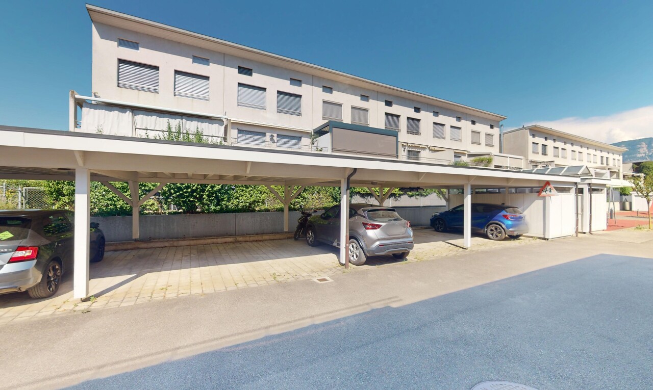 view of building exterior with covered parking