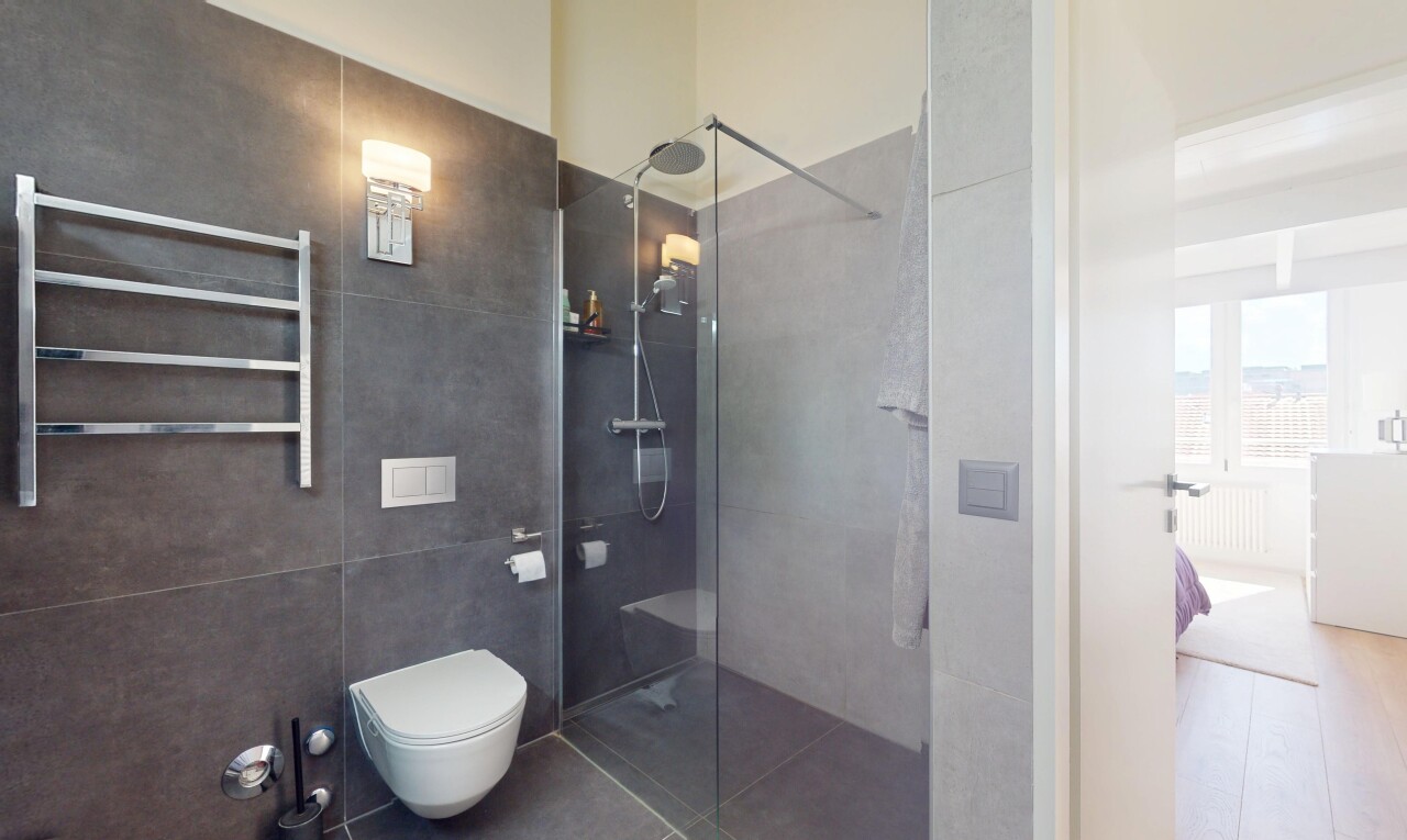 bathroom featuring radiator, walk in shower, and tile patterned flooring