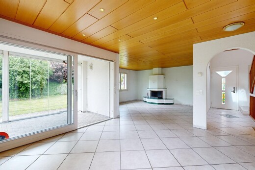 unfurnished living room featuring wooden ceiling, light tile patterned floors, and arched walkways