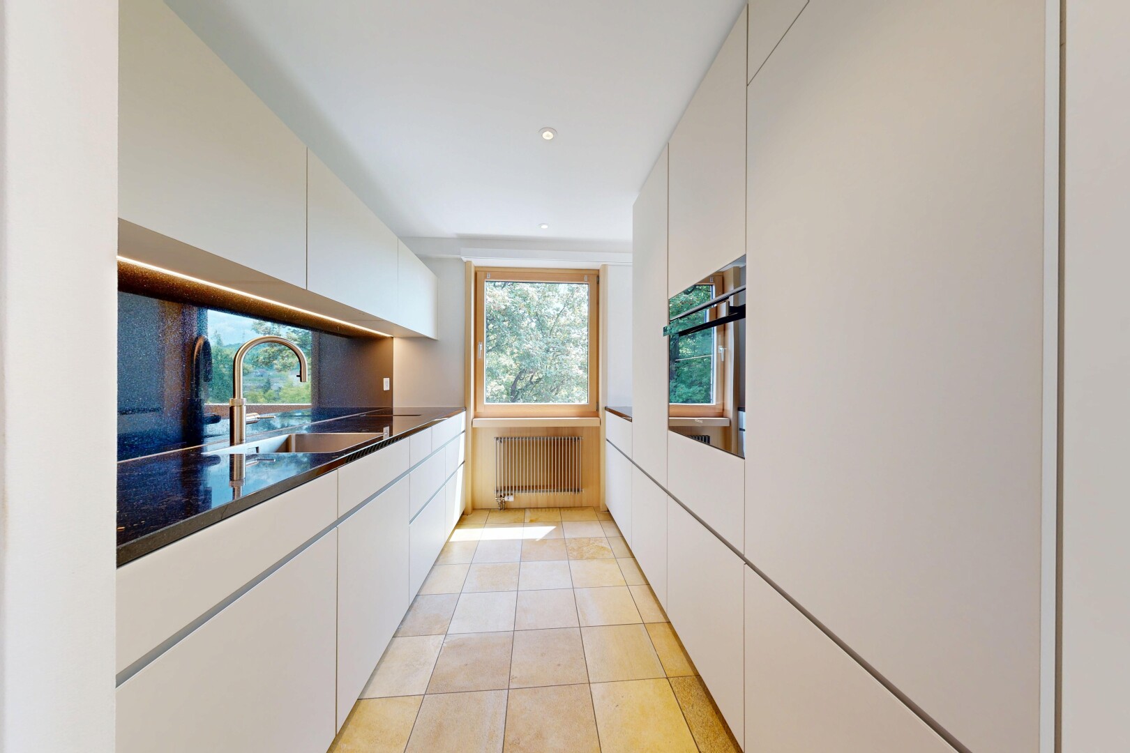kitchen featuring white cabinets, wall oven, radiator, and recessed lighting