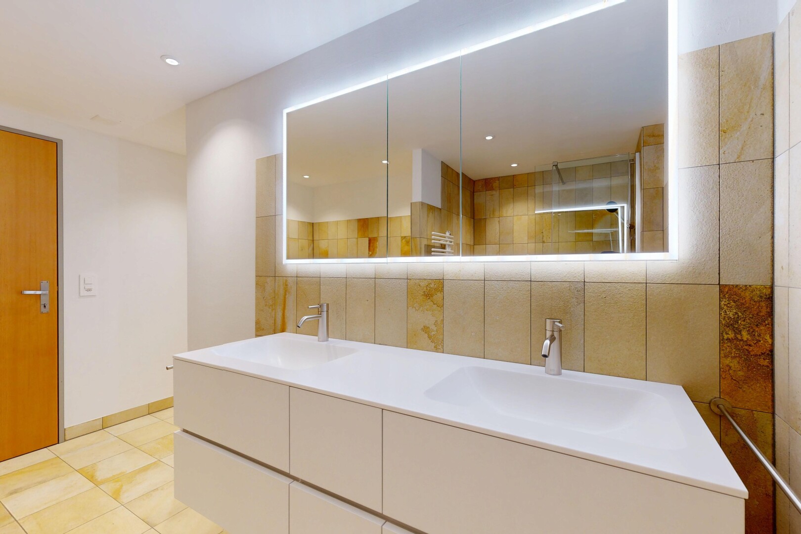 bathroom featuring double vanity, tiled shower, light tile patterned flooring, and recessed lighting
