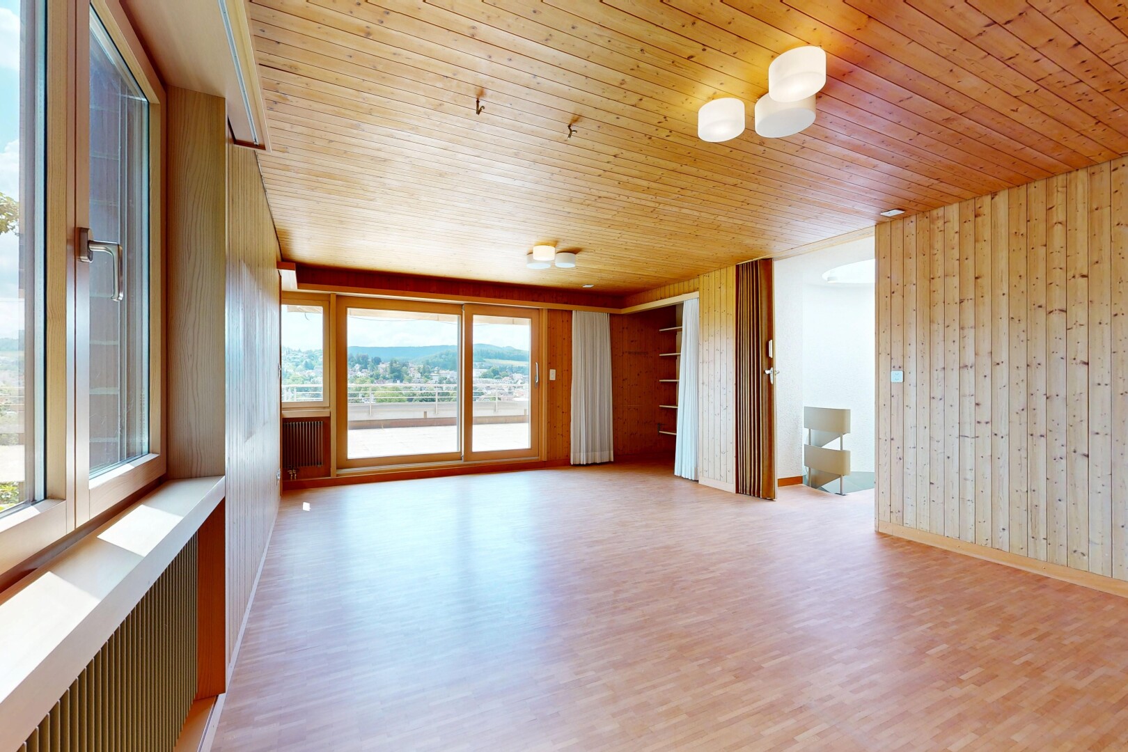 spare room with light wood-type flooring, wooden walls, and wooden ceiling