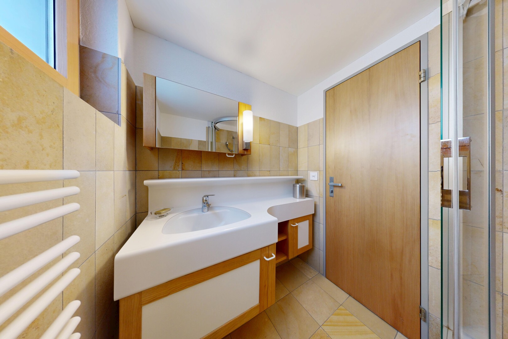 full bathroom with a towel warmer, tile walls, radiator, vanity, and light tile patterned flooring