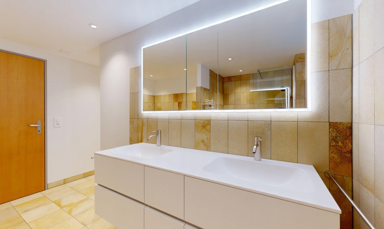 bathroom featuring double vanity, tiled shower, light tile patterned flooring, and recessed lighting