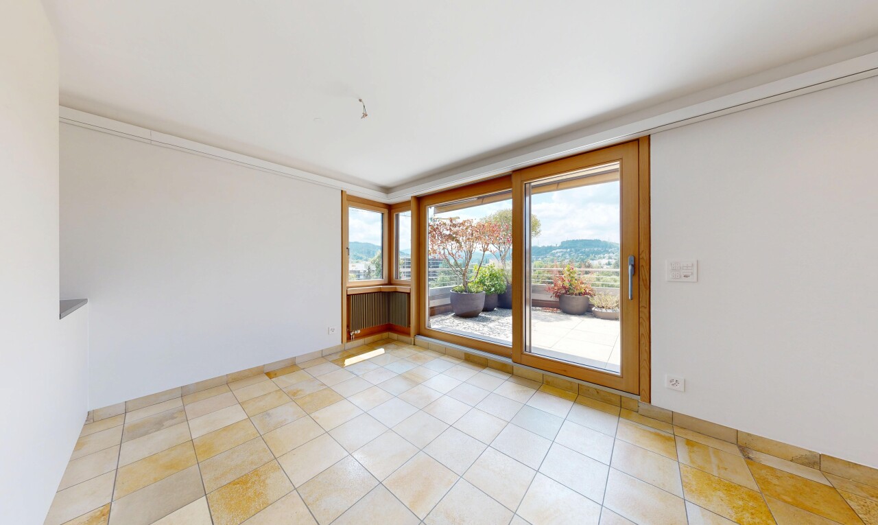 empty room with a mountain view, ornamental molding, and light tile patterned flooring