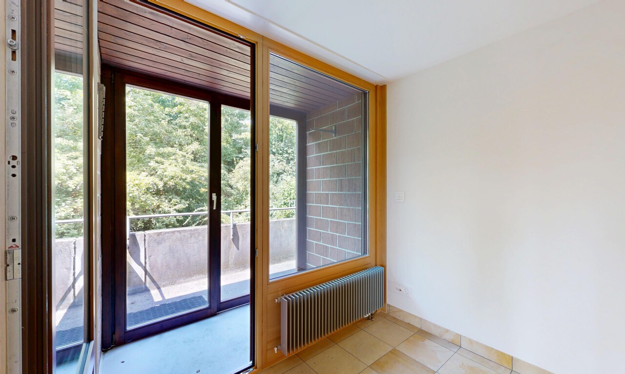 spare room featuring radiator heating unit and light tile patterned floors