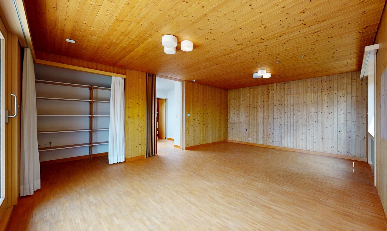 unfurnished room with light wood-style floors, wooden walls, and wood ceiling