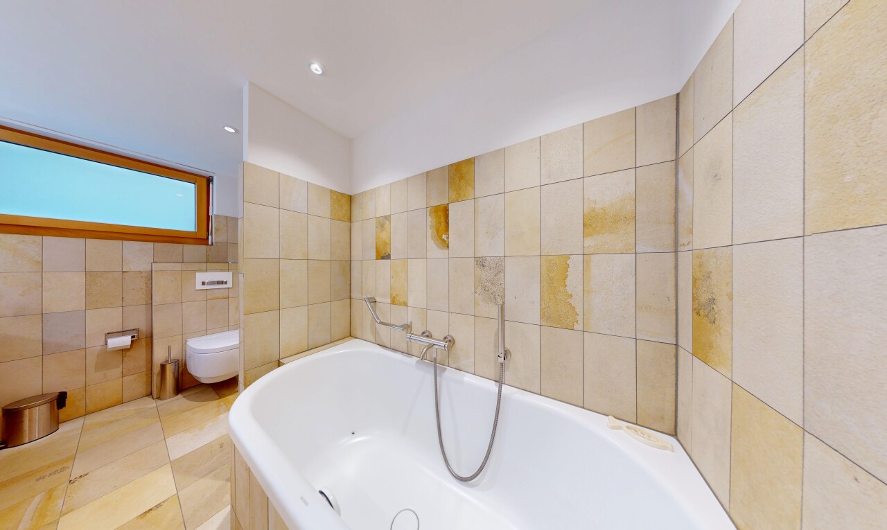full bathroom featuring a garden tub and tile walls