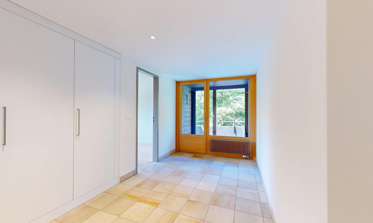 empty room with radiator and light tile patterned flooring