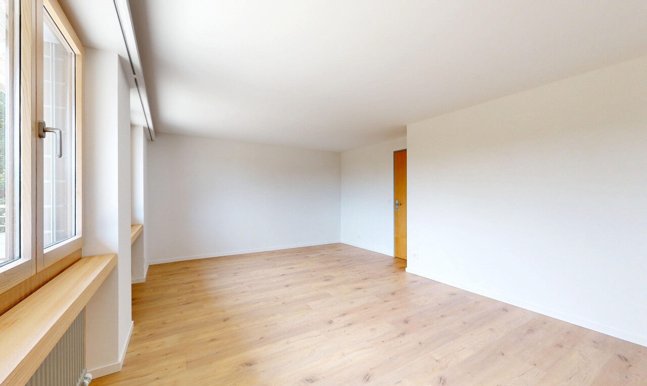 spare room featuring light wood-style flooring and radiator heating unit