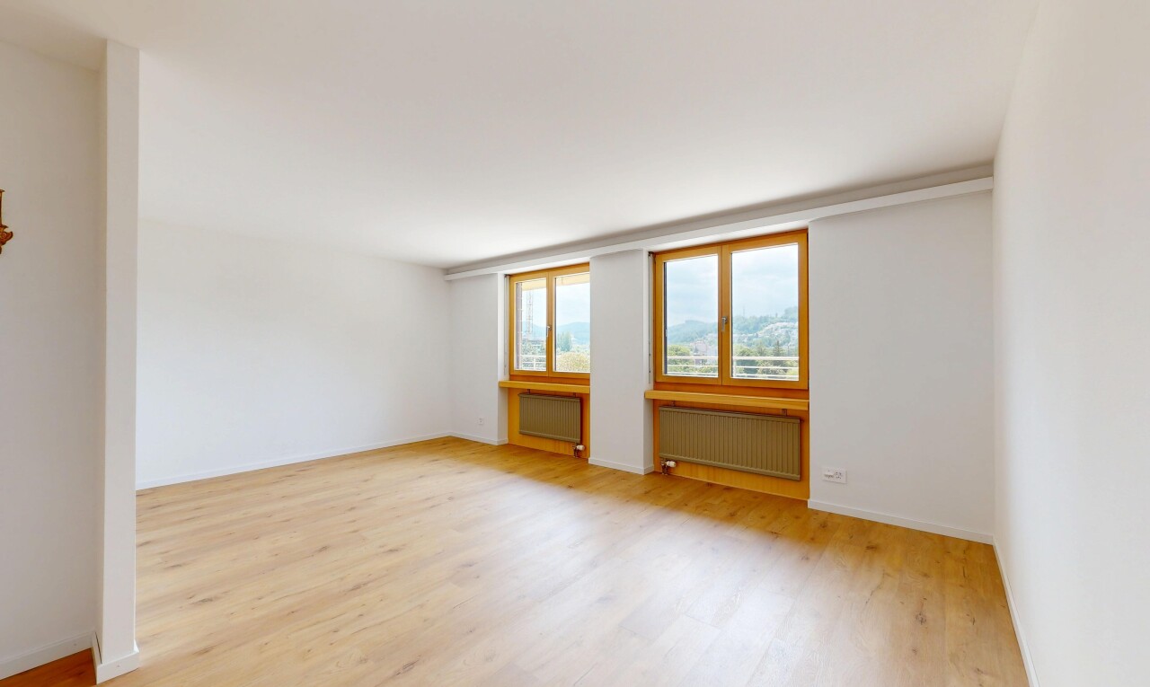 spare room featuring radiator heating unit and light wood finished floors