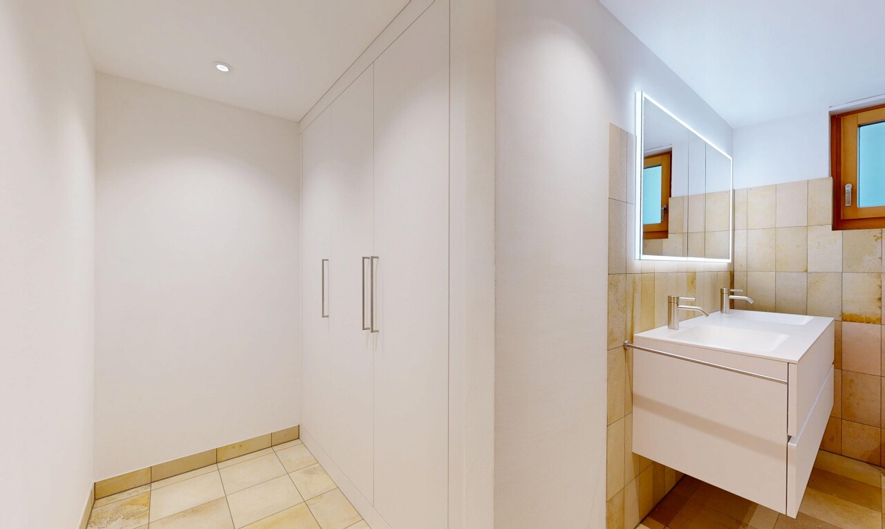 bathroom featuring vanity and tile walls