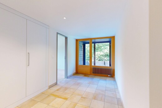 empty room with radiator and light tile patterned flooring