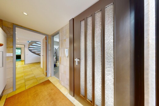hall featuring light tile patterned floors and recessed lighting