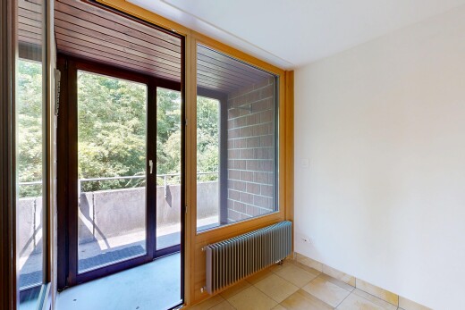spare room featuring radiator heating unit and light tile patterned floors