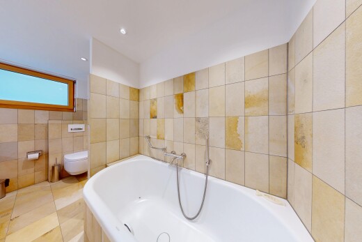 full bathroom featuring a garden tub and tile walls