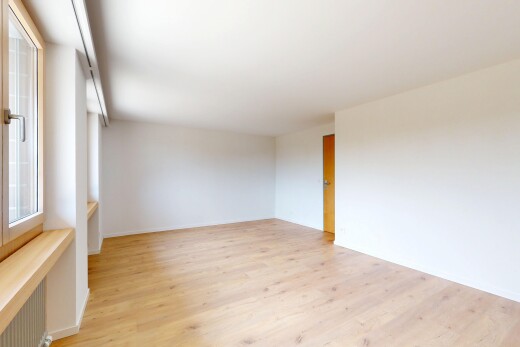 spare room featuring light wood-style flooring and radiator heating unit