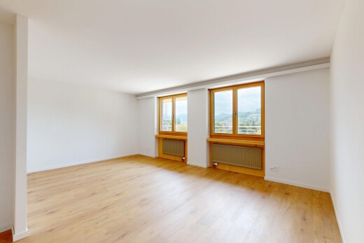 spare room featuring radiator heating unit and light wood finished floors