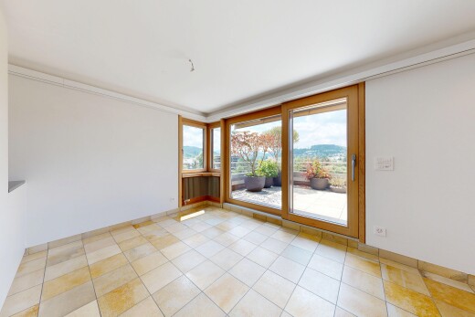 empty room with a mountain view, ornamental molding, and light tile patterned flooring
