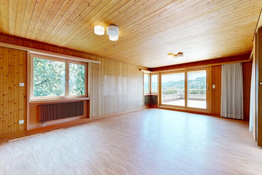 empty room with healthy amount of natural light, light wood-style flooring, radiator, wood walls, and wooden ceiling