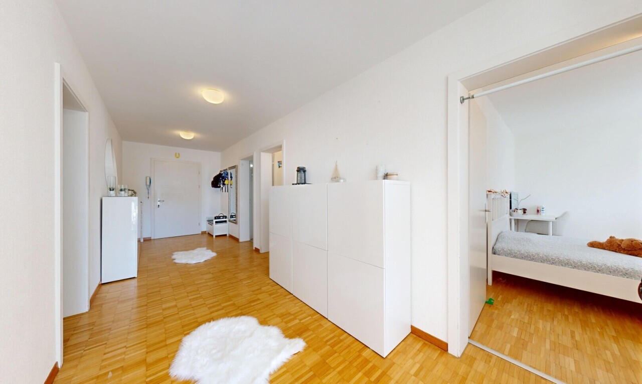 couloir avec drywall, cloison sèche, wood finish floor, sol en finition bois, et inside property