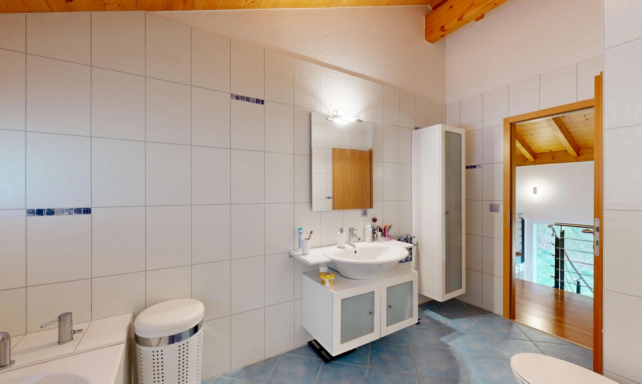 salle de bains avec lavabo (ou coiffeuse selon le contexte), mur en carrelage, tile wall, miroir, et salle de bain complète