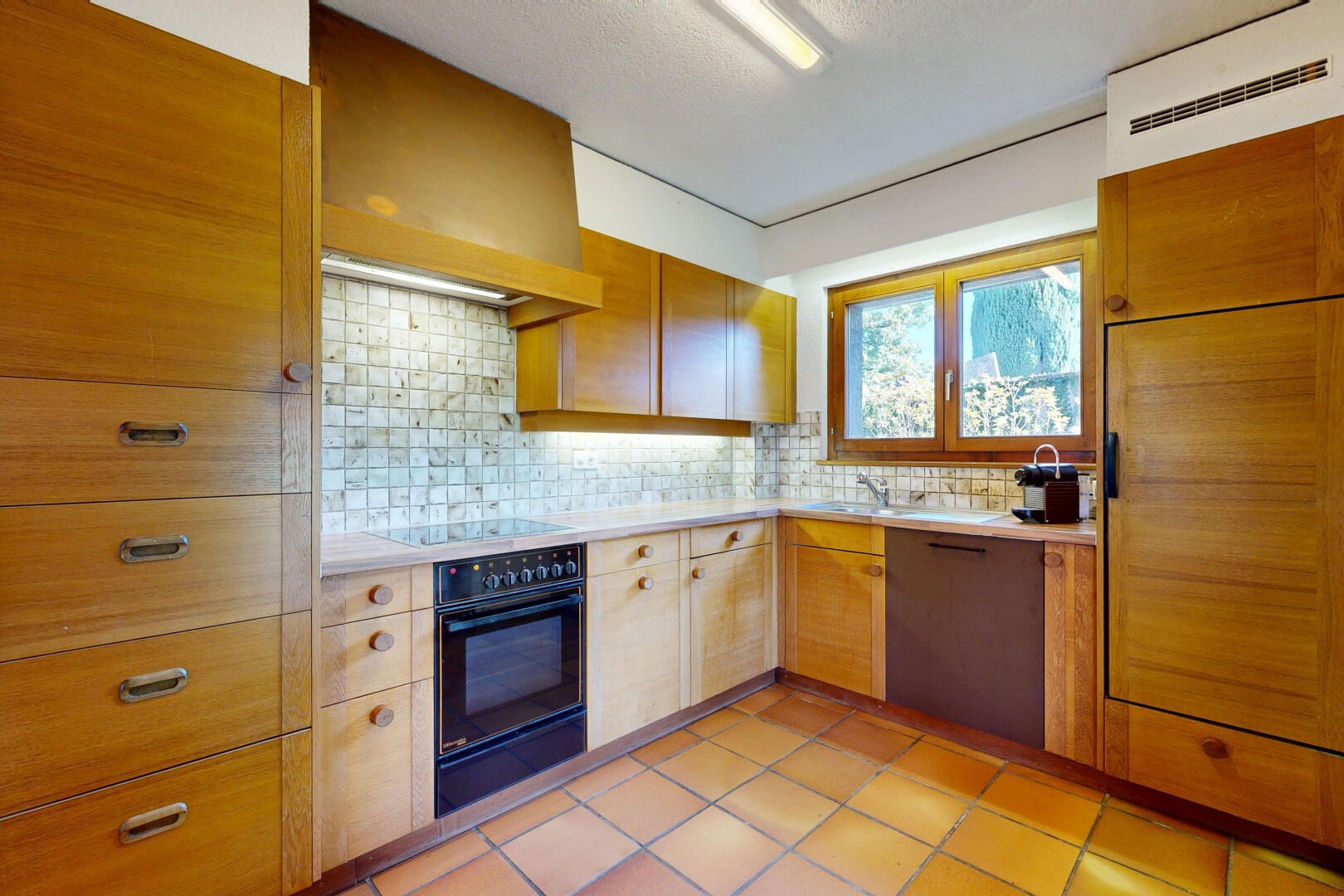 cuisine avec inside property, four, plans de travail, dosseret, et backsplash