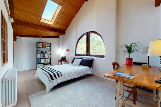 chambre à coucher avec plafond voûté, lumière naturelle, lucarne, et radiateur