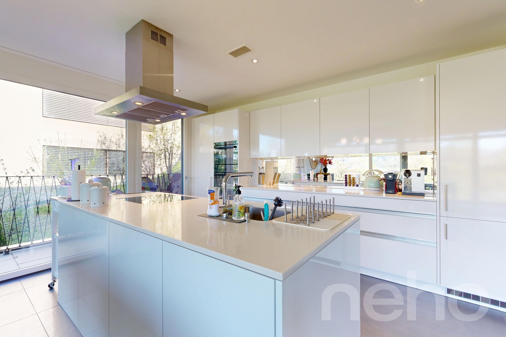 cuisine avec hotte, armoires à panneau plat, flat panel cabinets, light countertops, et îlot de cuisine