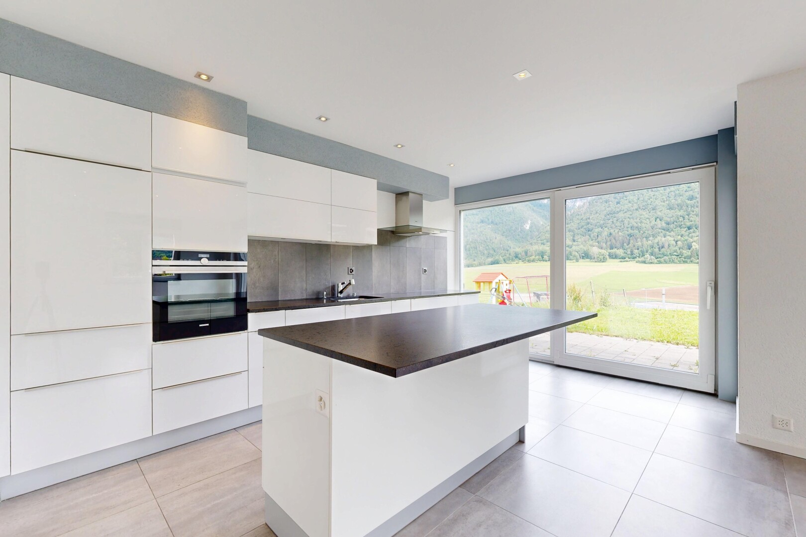 cuisine avec armoires blanches, white cabinets, four, inside property, et îlot de cuisine