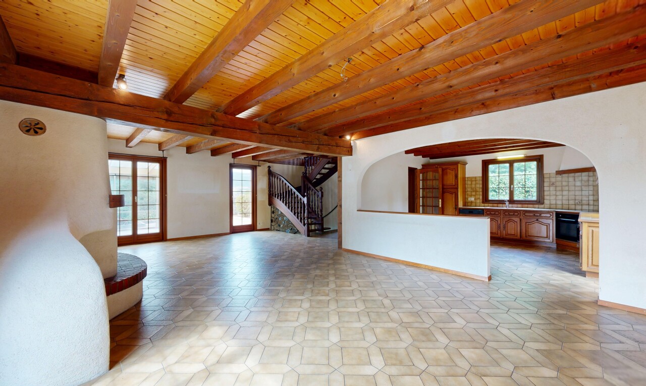 salon avec escaliers, passages en arc, plafond à poutres, beamed ceiling, et inside property