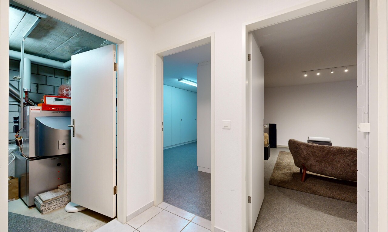 corridor featuring light colored carpet