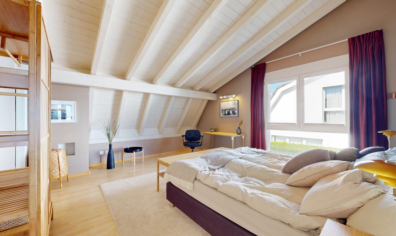 room featuring light wood-style floors and vaulted ceiling with beams
