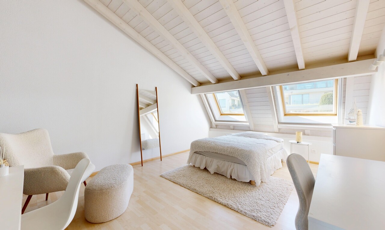 room / bedroom with light wood-style floors and lofted ceiling with beams