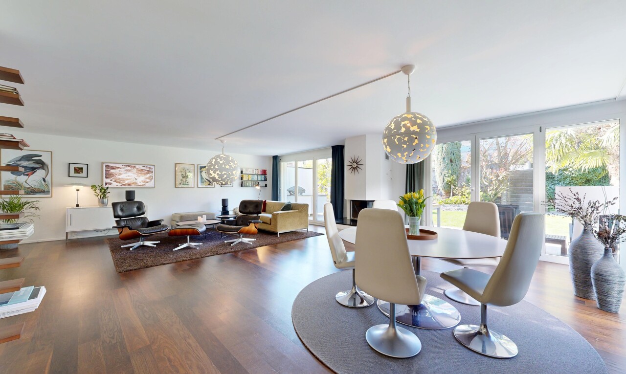 living / dining room featuring wood finished floors and suspended lighting