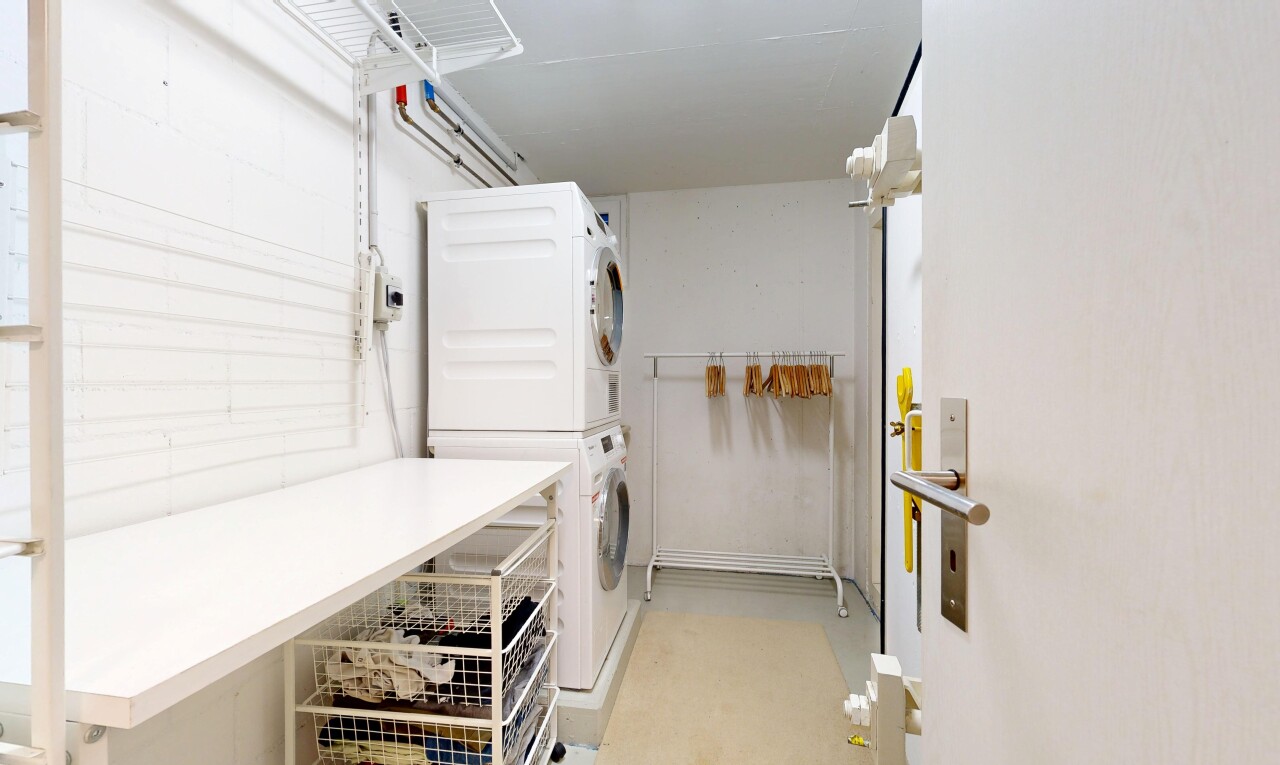 laundry area with stacked washing machine and dryer