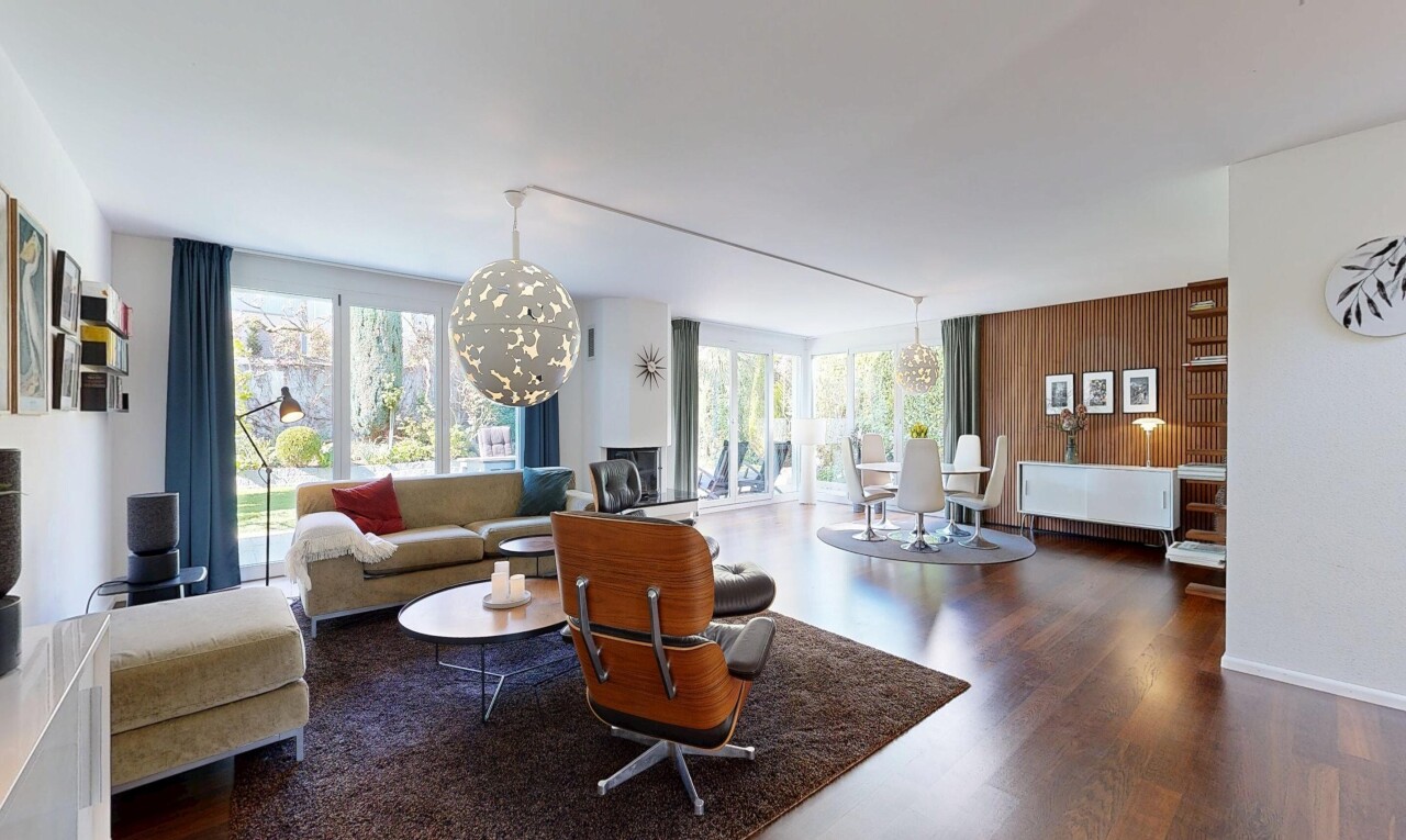 living area with a chandelier and dark wood-style flooring