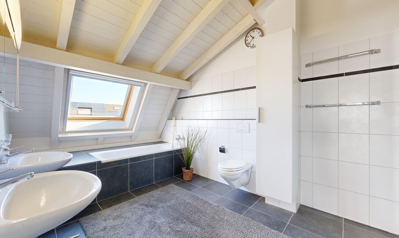 bathroom featuring lofted ceiling with beams, dark tile patterned flooring, and tile walls