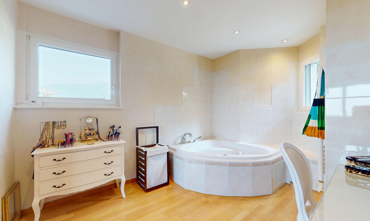 full bathroom featuring a garden tub and wood finished floors