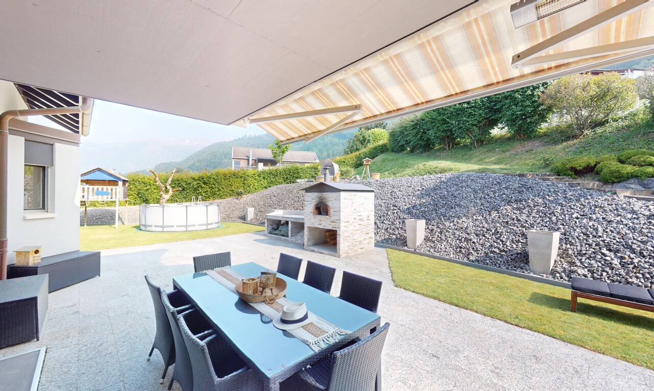 terrace featuring a patio, exterior fireplace, a mountain view, and outdoor dining space