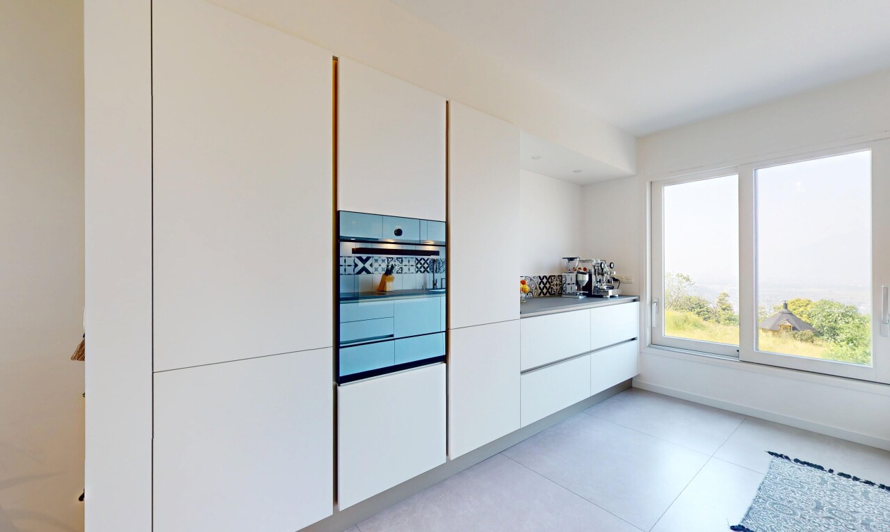 kitchen with white cabinets, light tile patterned flooring, and modern cabinets