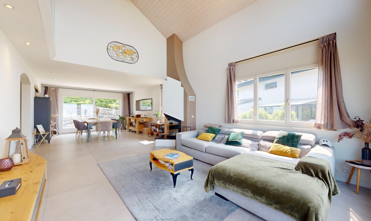 living / dining area featuring high vaulted ceiling and arched walkways