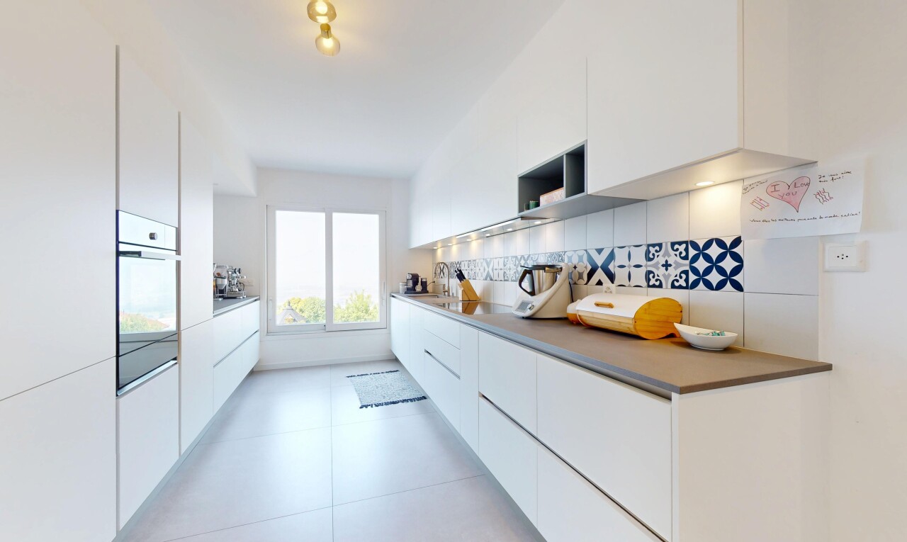 kitchen with oven, modern cabinets, white cabinetry, backsplash, and light tile patterned floors