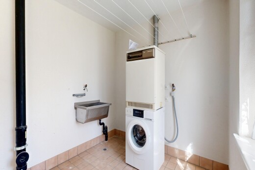 buanderie avec inside property, light floor, drywall, cloison sèche, et buanderie